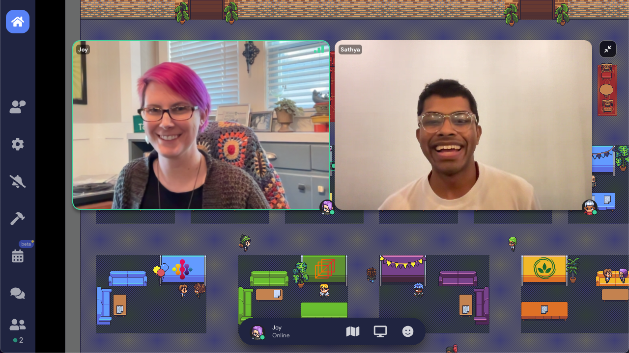 Two video feeds side by side in the Gather job fair Space. On the left is a pink-haired woman smiling and wearing glasses, and on the right is man also smiling and wearing glasses.