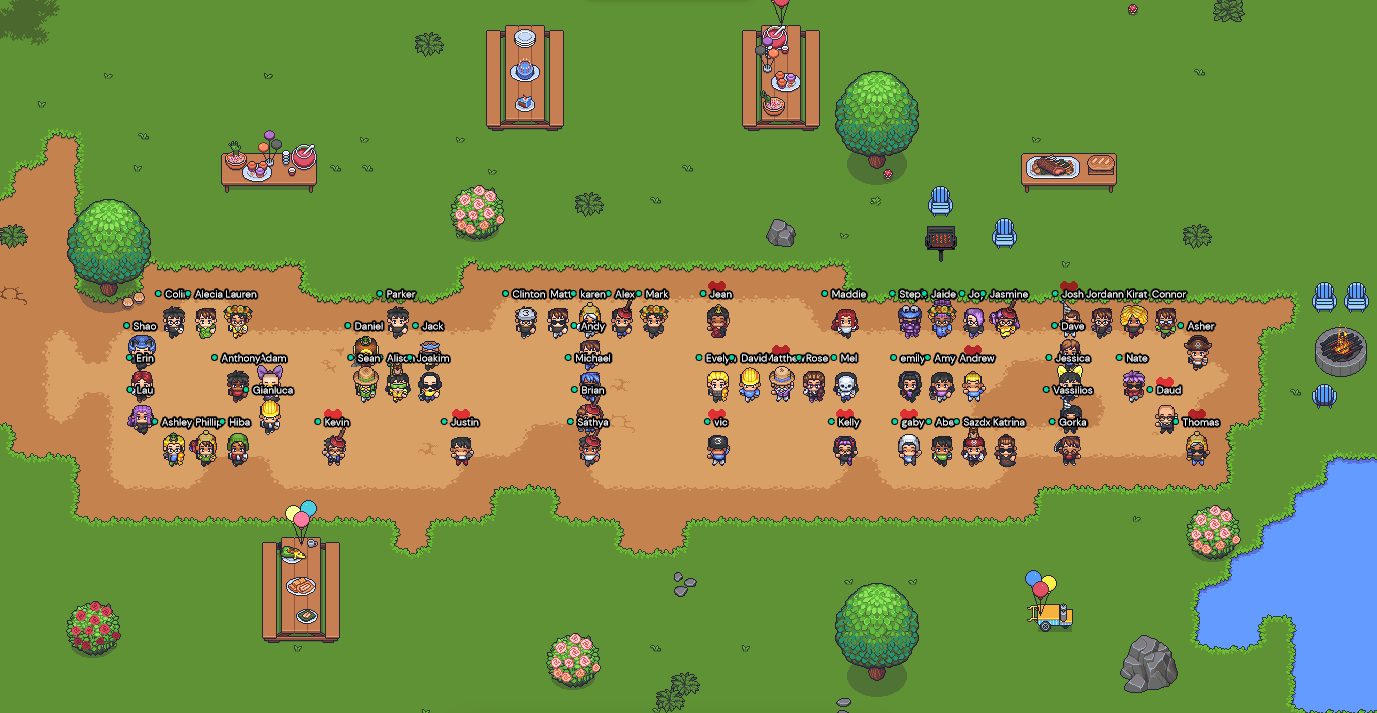 The avatars of the Gather staff are standing in an outdoor Space, spelling out the word Gather. Picnic tables, trees, and flowered bushes are scattered across the Space.